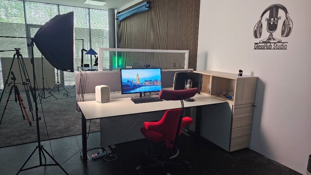 Podcast workstation with microphone, monitor and GlessHub Studio logo