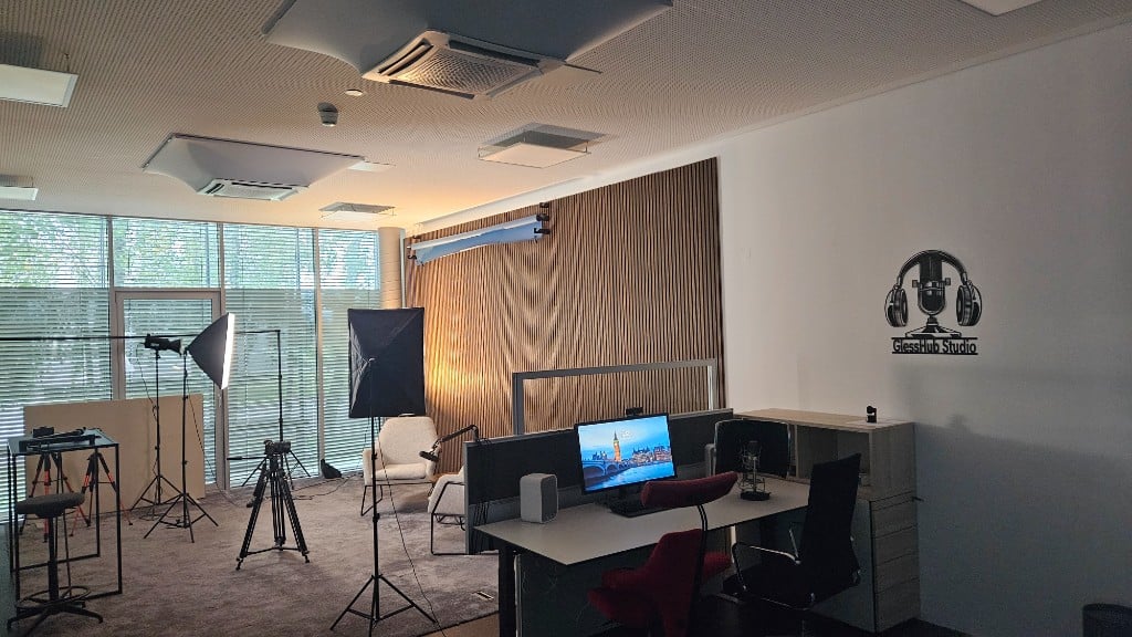 Overview of the GlessHub Studio with interview area, workstations and GlessHub Studio logo